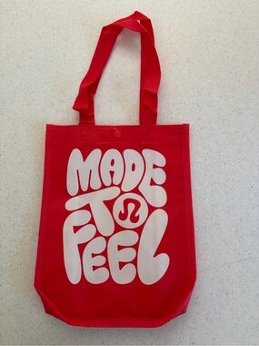 New lululemon athletica Red Tote with White 'Made to Feel' Graphic.